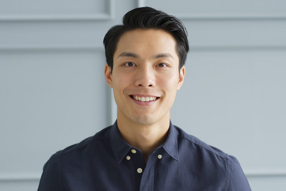 Portrait young confident smart Asian businessman look at camera